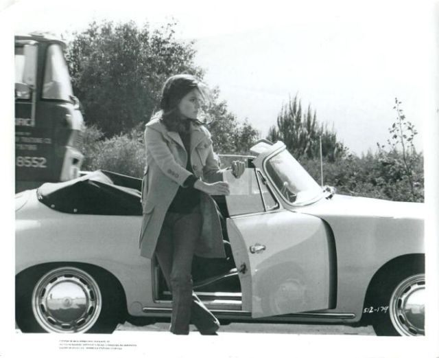 Jacqueline Bisset (as Cathy) getting out of her car.